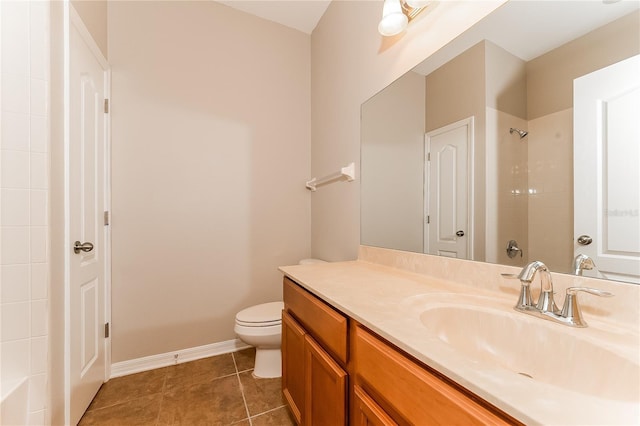 bathroom with a tile shower, tile patterned flooring, vanity, and toilet