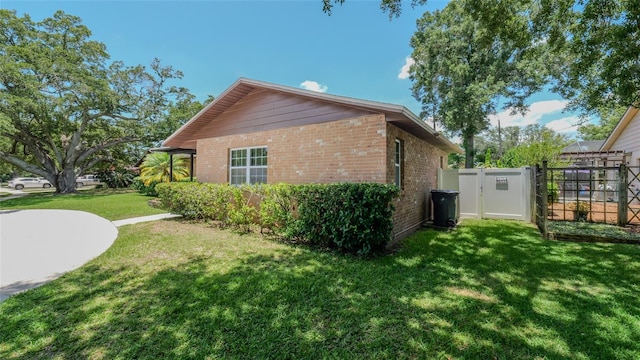 view of side of home with a yard