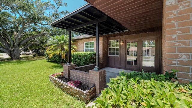 entrance to property featuring a lawn