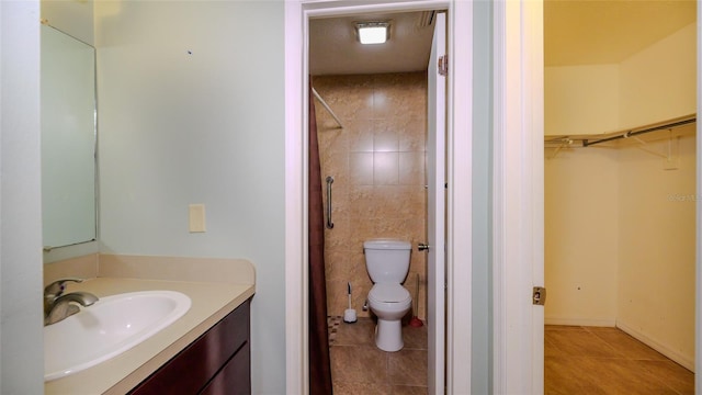 bathroom with tile patterned floors, vanity, and toilet