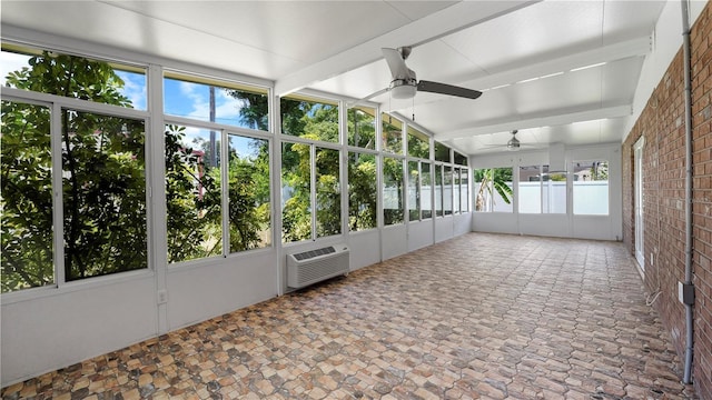 unfurnished sunroom featuring a wall unit AC, a wealth of natural light, and ceiling fan