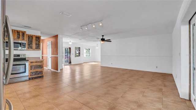 kitchen featuring ceiling fan, light tile patterned flooring, track lighting, and appliances with stainless steel finishes