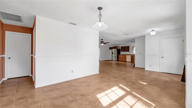 interior space with ceiling fan