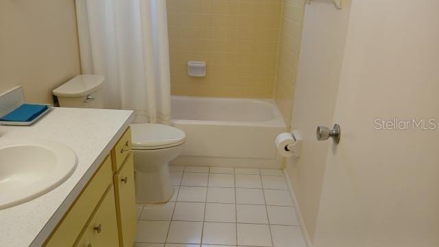 full bathroom featuring tile patterned flooring, vanity, toilet, and shower / bathtub combination with curtain