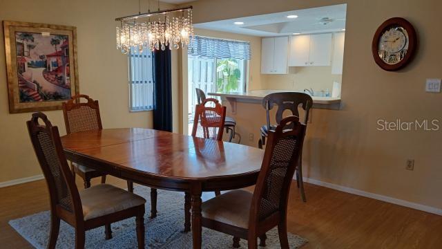 dining area featuring hardwood / wood-style flooring and a notable chandelier