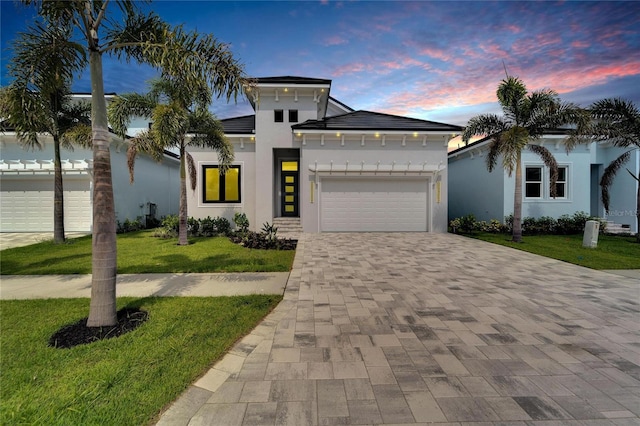 view of front of property with a yard and a garage