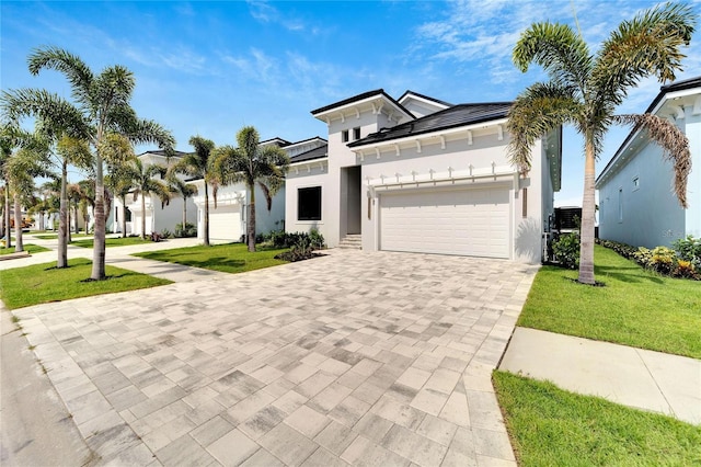 view of front of property featuring a front yard and a garage