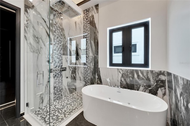 bathroom with tile patterned floors, french doors, plus walk in shower, and tile walls