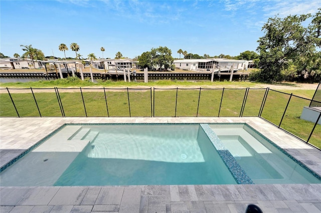 view of swimming pool featuring a lawn, an in ground hot tub, and a water view