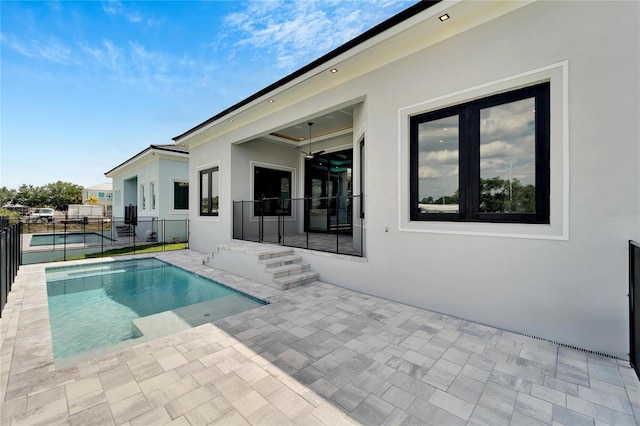 view of pool featuring ceiling fan and a patio