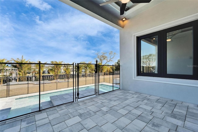 exterior space featuring a ceiling fan, fence, and a fenced in pool