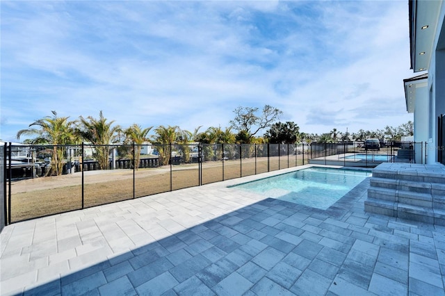 view of pool featuring a fenced in pool, a patio area, fence, and an in ground hot tub