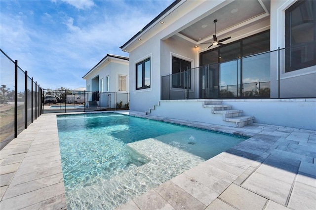 view of swimming pool featuring a fenced in pool, a patio area, fence, and ceiling fan