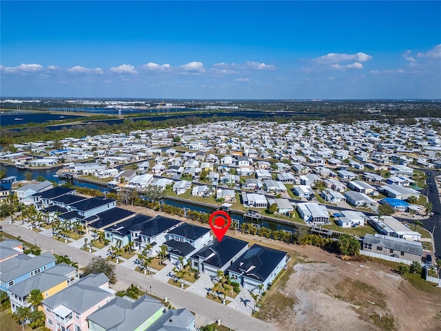 drone / aerial view featuring a water view and a residential view