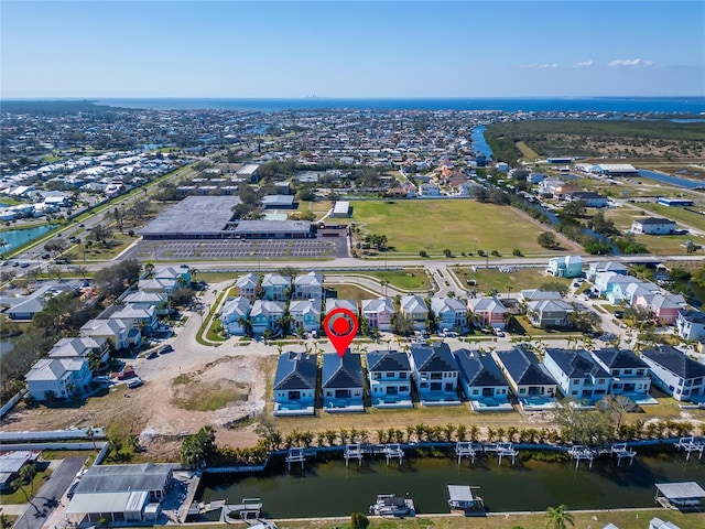 birds eye view of property with a water view and a residential view