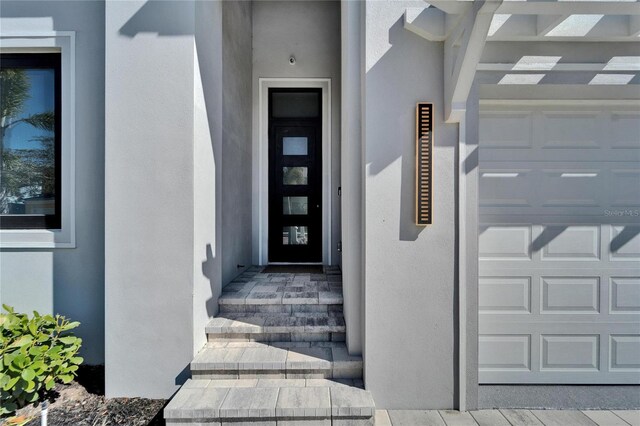 doorway to property with a garage