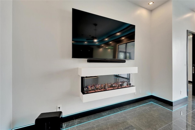 room details with baseboards and a multi sided fireplace