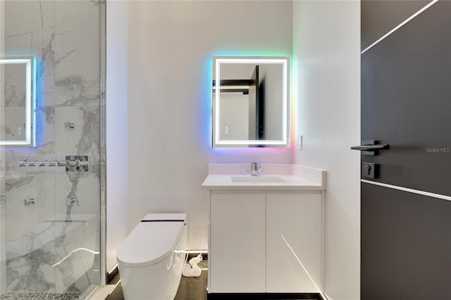 full bath featuring toilet, a marble finish shower, and vanity