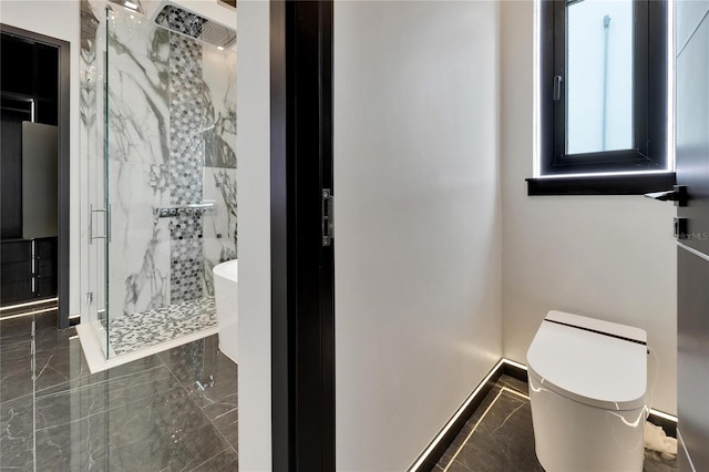 bathroom featuring marble finish floor, toilet, and a marble finish shower