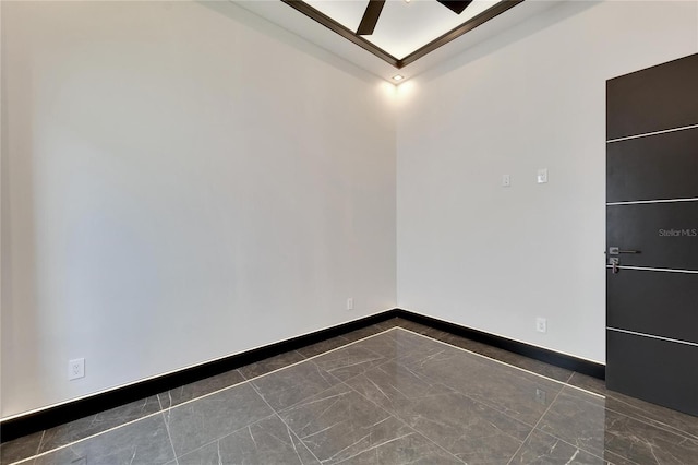 unfurnished room featuring a ceiling fan, marble finish floor, and baseboards