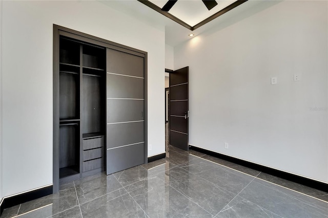 unfurnished bedroom featuring marble finish floor, a closet, recessed lighting, and baseboards