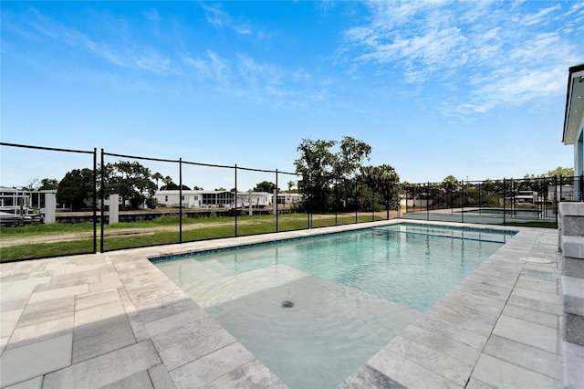 pool featuring a yard and fence