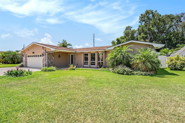 single story home with a front yard and a garage