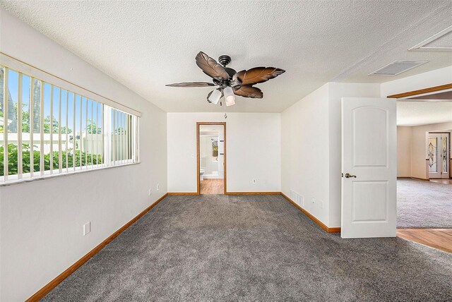 spare room with ceiling fan, hardwood / wood-style floors, and a textured ceiling