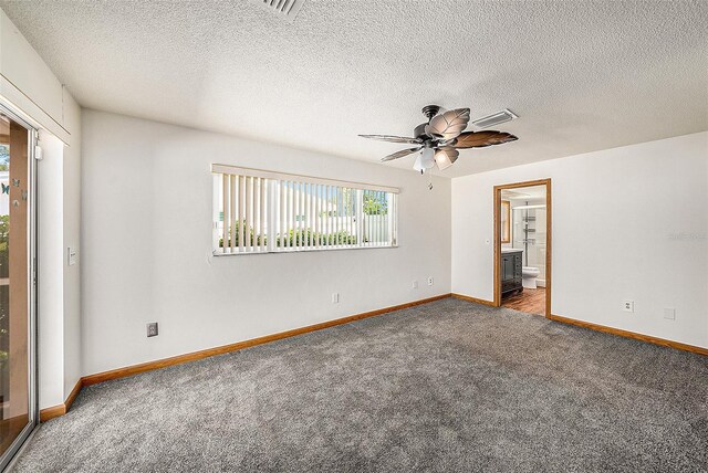 unfurnished bedroom with carpet, ceiling fan, a textured ceiling, and connected bathroom