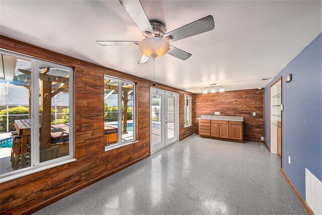 interior space with ceiling fan and french doors