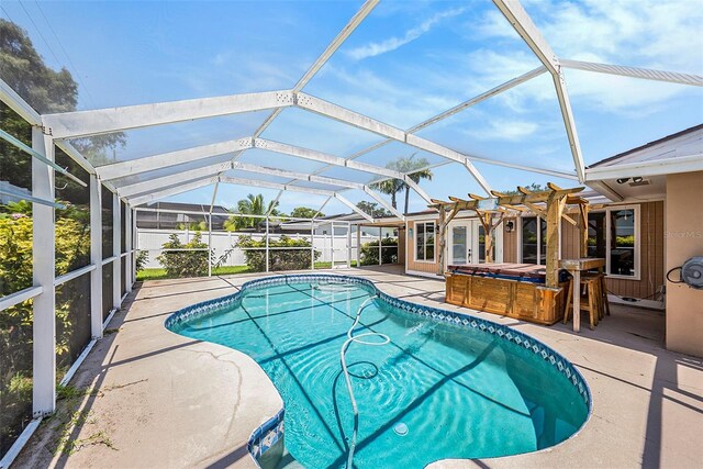 view of swimming pool with a pergola, a patio area, a lanai, and a hot tub