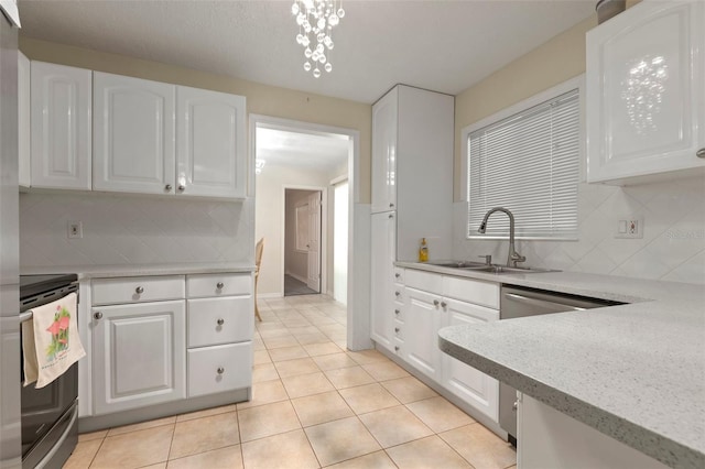 kitchen featuring decorative backsplash, sink, white cabinetry, and stainless steel appliances