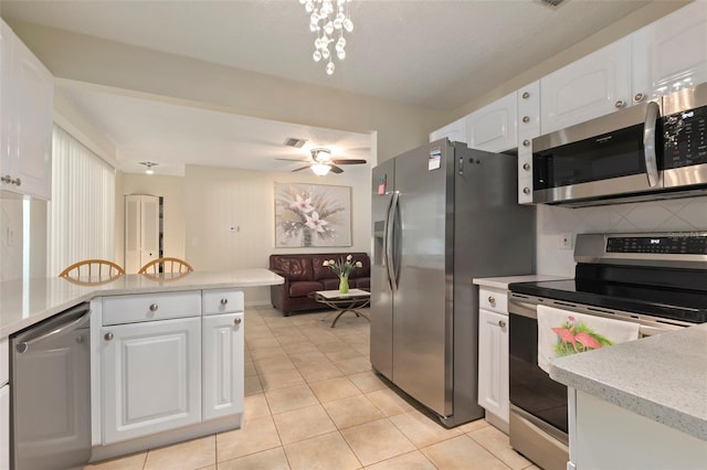 kitchen featuring ceiling fan, tasteful backsplash, light tile patterned flooring, white cabinets, and appliances with stainless steel finishes