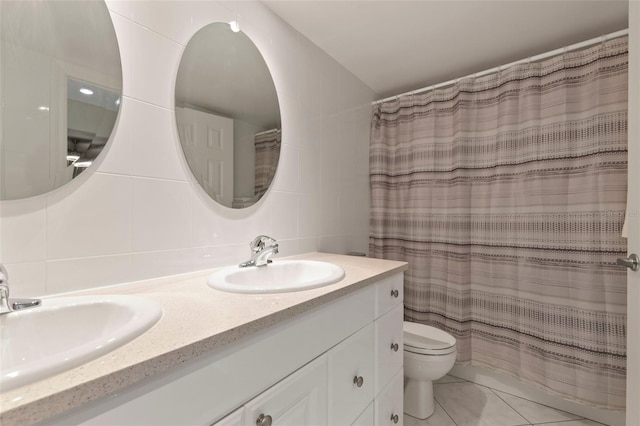 bathroom featuring vanity, tile patterned floors, a shower with shower curtain, toilet, and tile walls