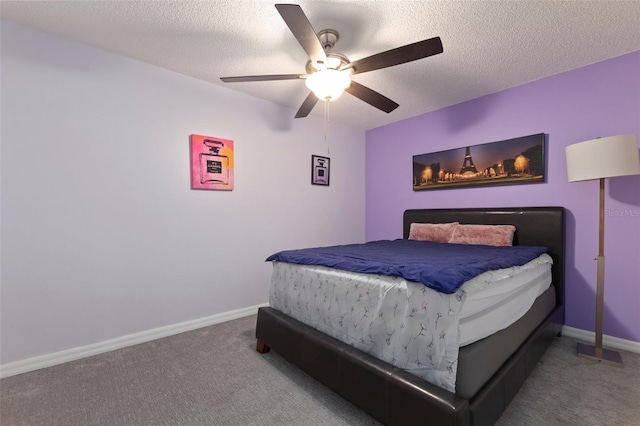 carpeted bedroom featuring a textured ceiling and ceiling fan