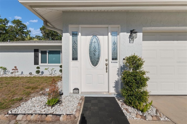 view of exterior entry with a garage