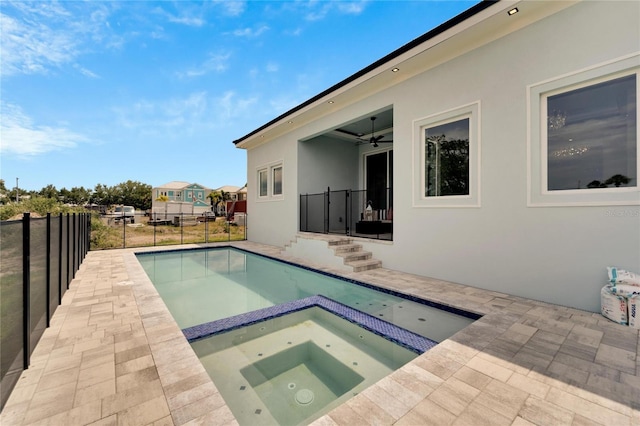 view of swimming pool featuring an in ground hot tub and a patio