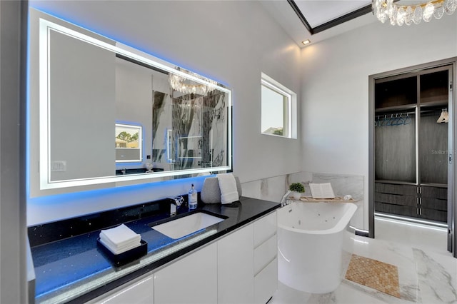 bathroom with vanity and a bath