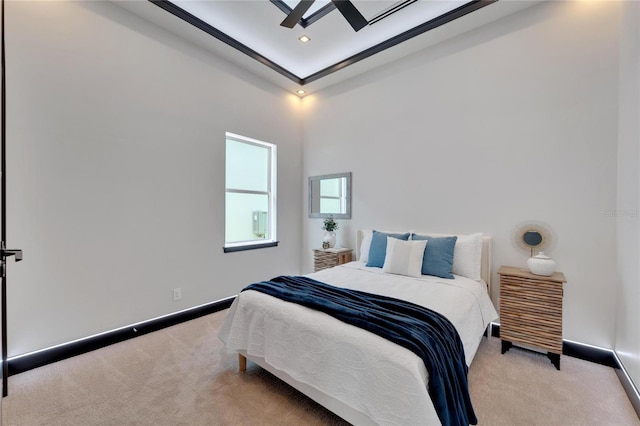 bedroom with ceiling fan and light colored carpet