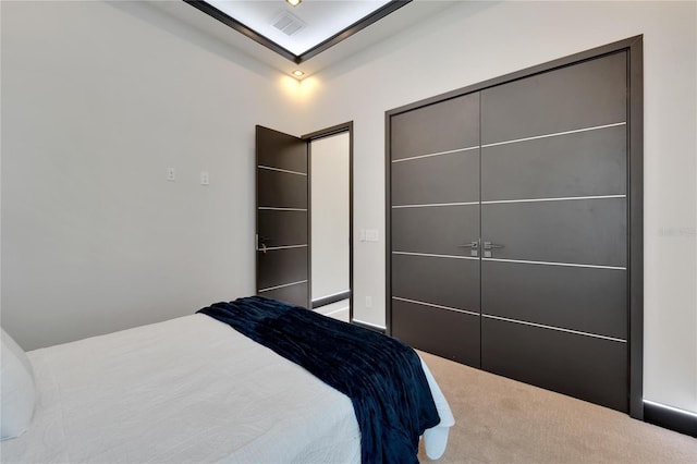 bedroom with carpet floors, vaulted ceiling, and a closet