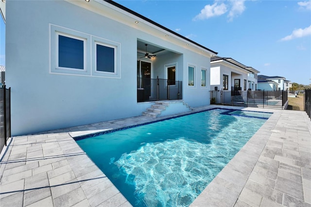 view of swimming pool with a fenced in pool, fence, a ceiling fan, and a patio