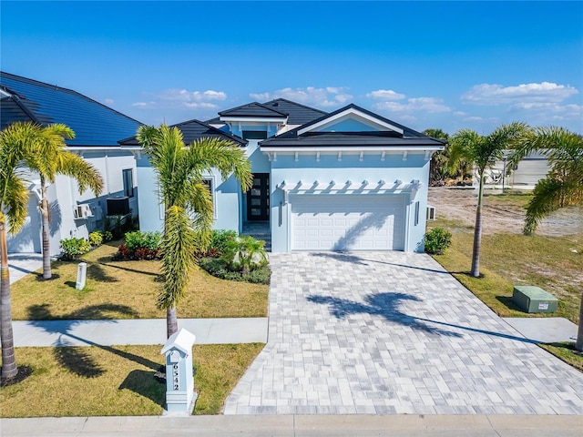 6542 Simone Shores Cir, Apollo Beach, FL 33572 - view of front of house featuring a front yard, decorative driveway, stucco siding, and an attached garage