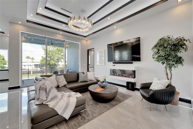 6542 Simone Shores Cir, Apollo Beach, FL 33572 - living area with a raised ceiling, a chandelier, marble tiled flooring, recessed lighting, and baseboards