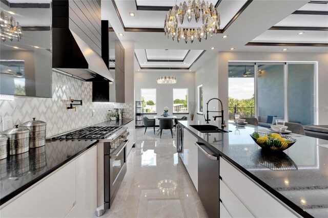 6542 Simone Shores Cir, Apollo Beach, FL 33572 - kitchen featuring stainless steel appliances, a raised ceiling, a chandelier, modern cabinets, and a sink