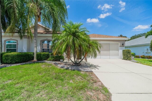 view of front of home featuring a garage and a front yard