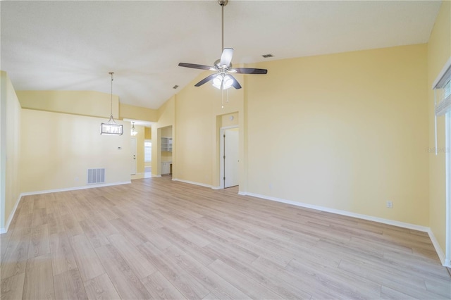 empty room featuring light wood-type flooring, baseboards, visible vents, and lofted ceiling