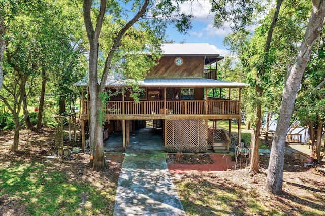 exterior space with a wooden deck and a carport