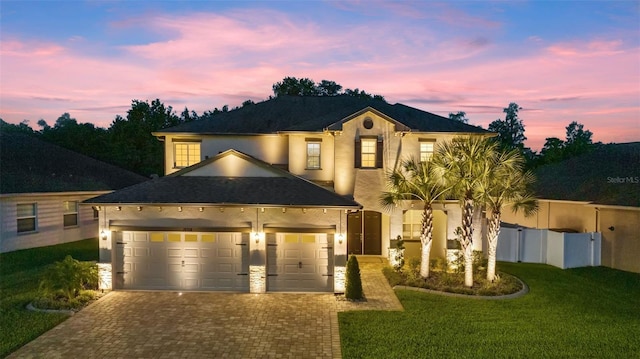 view of front of property with a lawn and a garage