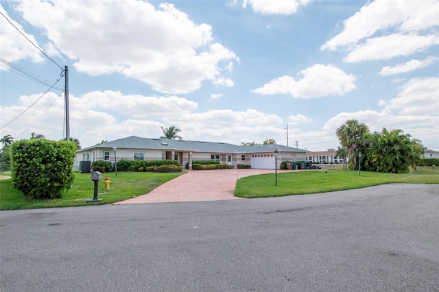 ranch-style home with a front lawn and a garage