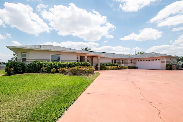 ranch-style home featuring a garage and a front lawn